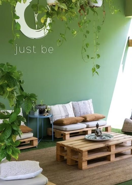 The Just Be garden lounge with plants and floor cushions